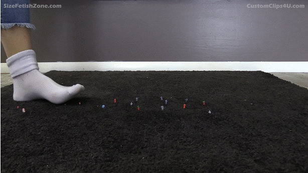 Keri Spectrum is wearing red nail polish on her toes and fingers. 
<br><br>
    She walks into a room, and she doesn't notice a number of small tiny people on the floor. The people are small "tinies" that go with train sets.
<br><br>
    She is wearing tight white ankle socks. She walks on top of some tiny people. She feels them crush underfoot. That's when she notices the tiny people on the floor. She recognizes one as "Aaron" and she tells Aaron that she will torture and crush all of his friends.
<br><br>
    Please shoot her feet from up above, looking down at her feet, as opposed to shooting at ground level.
<br><br>
    She says that she wants to feel the people crush under her bare feet, so she takes her socks off.
<br><br>
    She plays with the people between her toes and under her feet.  Please have some close-ups of her toes, as well as some shots that show the entirety of her feet from toes to heels.
<br><br>
    She grinds some people under her toes, the balls of her feet, and her heels as she forces Aaron to watch.
<br><br>
    She sits on her knees so her feet are behind her, with her soles facing up. She puts people (including Aaron) on her soles and between her toes, forcing them to worship her like the goddess she is.
<br><br>
    At the end of the video, she puts the people (including Aaron) into her flat shoes. She puts her foot into the flat and she says she loves feeling the people being crushed and walks away.