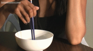 Tenshi has a bowl with a few shrunken people trapped inside it. She teases them and picks them up one by one with chopsticks. She eats them up, chewing on them individually, then swallowing each down.
