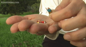 The first part of a story featuring Sinthia. A group of people got her kicked out of the mall, so she has captured them to torment in the park. The first two she decides to squish under her feet. One is played with under her toes in her sandal. Sinthia finally crushes the tiny girl under her sandal. The other is played with by her bare toes, and rubbed shortly against her sole before being squished under her heel. This video can be enjoyed on its own and is just under seven minutes long.
